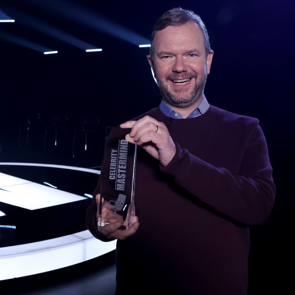 Celebrity Mastermind James O'Brien with trophy + set in background (1)